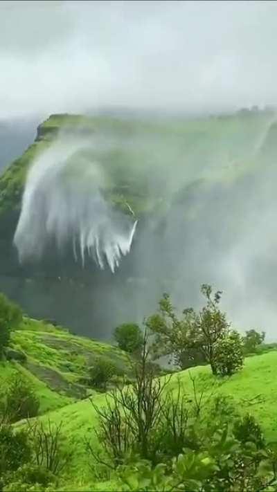 Waterfall flows upwards from strong winds, Naneghat, India