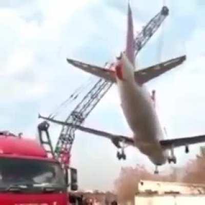 Crane breaks while carrying a scrap plane. Unknown date