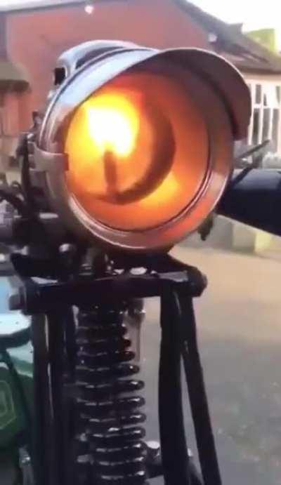 Lighting the carbide lamps on a 1920s motorcycle