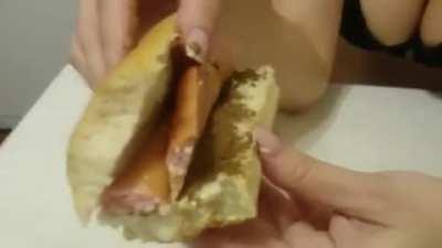 Cute girl shits in a hotdog bun and eats it