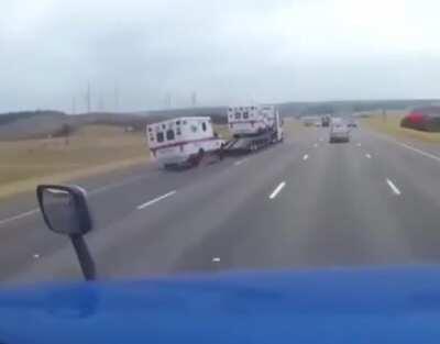 Ambulance falls off a transport trailer