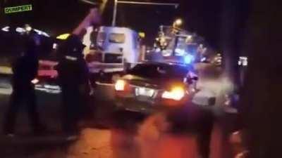 Impatient BMW driver pushes police car out of the way