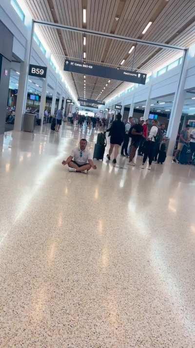 Spreading his worldview in an airport and freaking out when everyone calls him out for it