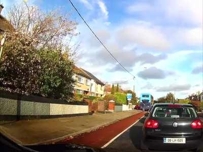 Cyclist sharing bike lane with bus Dublin, Ireland.