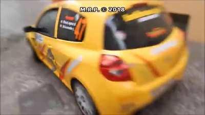 Rally cars squeezing past through narrow street