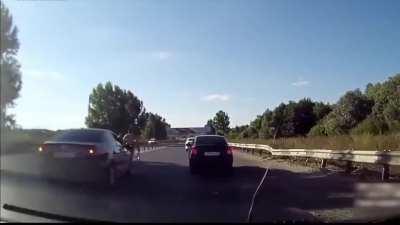 2 men throw off the road a cyclist