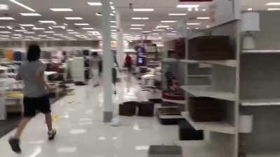 Dozens of people loot the Target store near Minneapolis Police's 3rd Precinct building in the midst of the George Floyd protest.