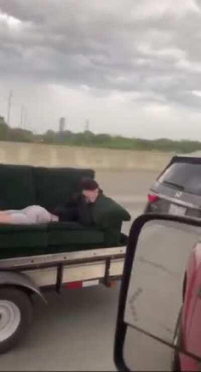 ~~Idiot~~ Dude on sofa, on a trailer, while going on the highway