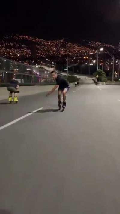 Freeway at night dwarfed by city underneath