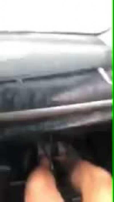 Rolling the window down to film a puddle.