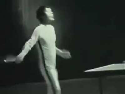 Bruce lee 2v1-ing table tennis players using nunchucks