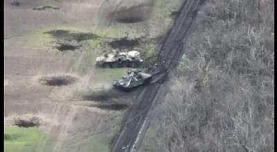 Russian tank hits mine, then as crew are scrambling to dismount, it is hit with an ATGM that sends the driver flying through the air