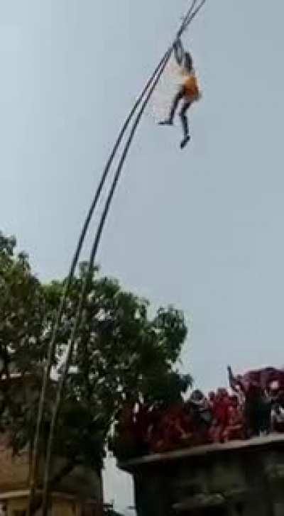 Guy falls off a bamboo pole