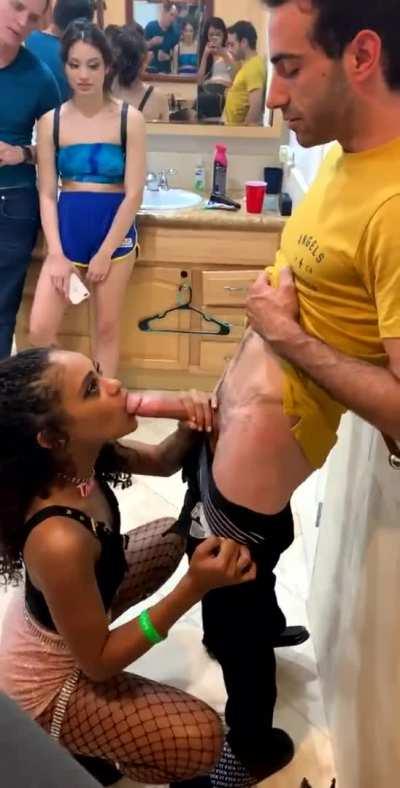 Black girl blows a cock in front of others