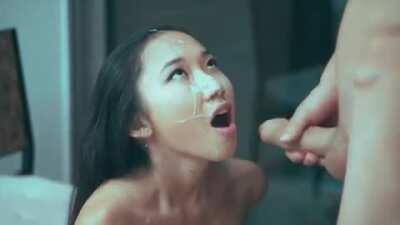 Stroking out a big load all over her pretty face