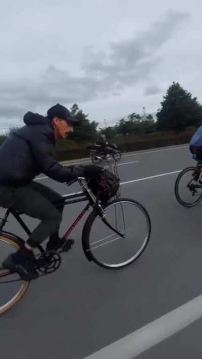 Commuter with basket keeping pace with some roadies