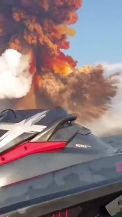 A Man avoids the Shockwave from an explosive blast by jumping into the water. The blast originated in the Port of Beirut. 2,750 tonnes of ammonium nitrate was detonated which resulted in hundreds of deaths and thousands of injuries & $15 billion in da