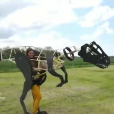 This artist testing out a prototype of her full-body velociraptor puppet | By Esmee Kramer