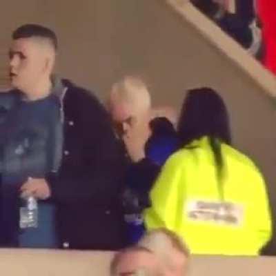Man wipes snot in woman's hair at football match