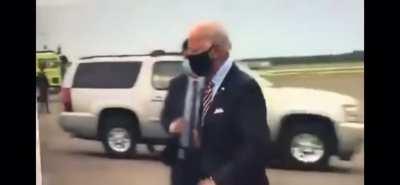 Biden waving to an empty field