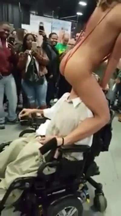 Adriana Chechik giving a disabled fan a taste