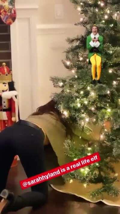 On her knees in tight pants.