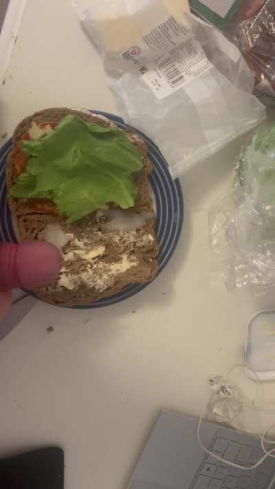 Adding some sauce to the sandwich Im making