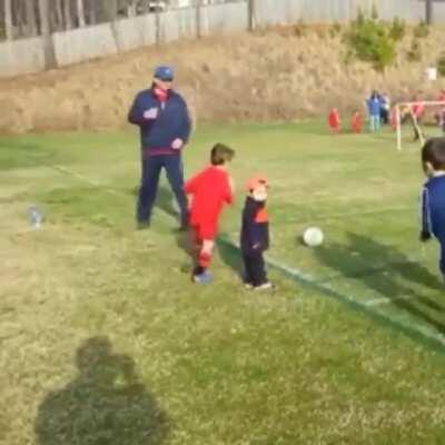 This kid hugging his little brother during the game