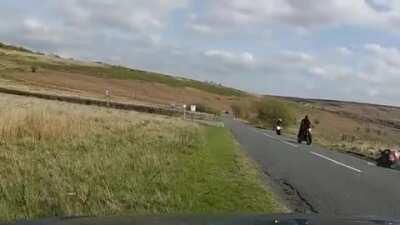 Subaru driver loses it on a bend and hits biker. Biker was ok.