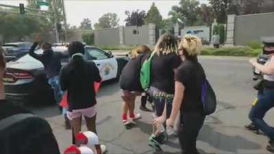 Protester gets sent flying after jumping on highway patrol vehicle - Sacramento, CA 14th September