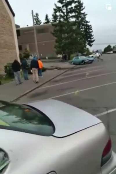A classic 1964 Ford Thunderbird somehow slips into reverse while the owner is working under the hood with the motor idling. It proceeds to do uncontrolled donuts until destroying itself against a pole.