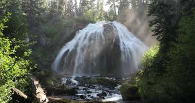 Sunlight hitting the spray at Chush Falls in Oregon.