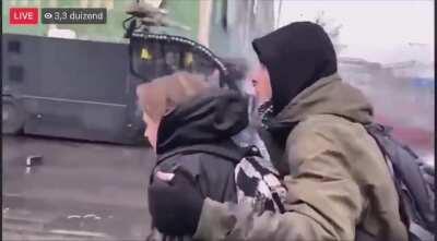 Woman gets blasted with a watercanon at a protest. Eindhoven, the Netherlands.