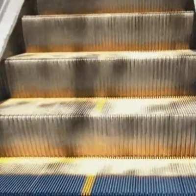 Light hitting an escalator like a waterfall of sand