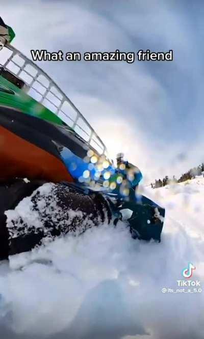 Guy lifts 400 pound snowmobile to save his friend.