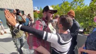 Netflix employees attacks a man for having a 'WE LIKE DAVE' sign.