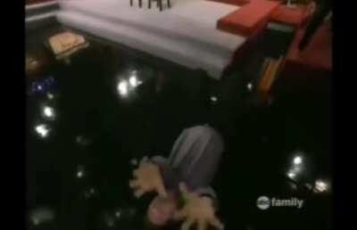 Cameraman of an improv show joining in the comedy.