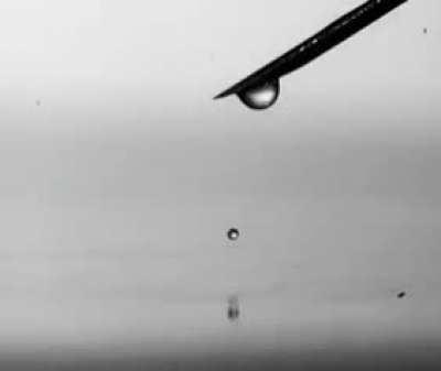 A drop of water falls into the water, filmed with a high-speed video camera.