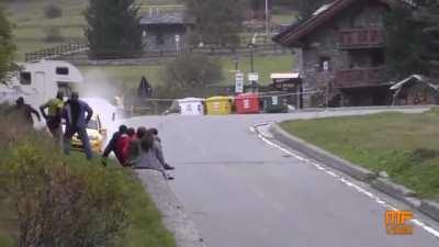 Rally car barely misses 8 people who though they were safe