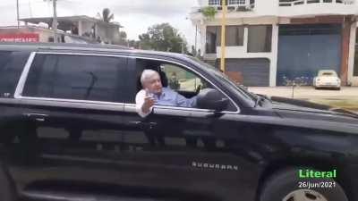 México president driving next to a civilian with an ilegal weapon