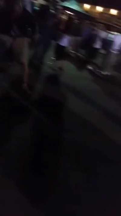 Throwing a bottle into a crowd