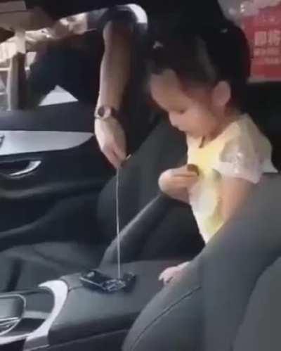 Kid helping her dad ...