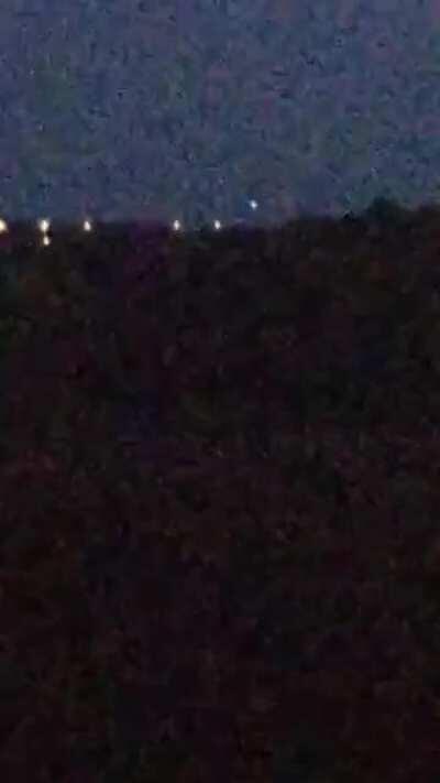 15 09 20 UK 3 lights dancing about probably 4 miles off. Row of lights below are street lamps.