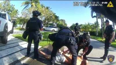 While a man is having a calm conversation with a police officer, 5 other officers sneak from behind and tackle him to the ground
