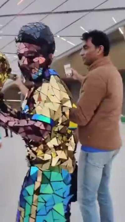a Brazilian football fan covered himself completely in mirrors.
