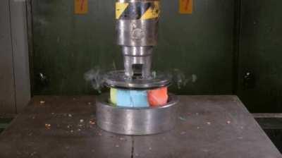 These colored candles vs a hydraulic press