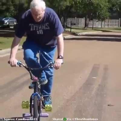 BMX Dad casually pulling off insane trick.