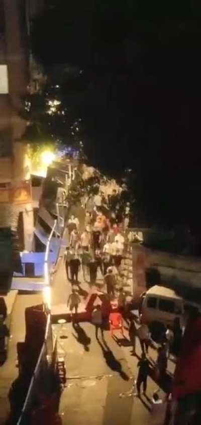 People kicking down barriers in the locked down area of Haizhu, Guangzhou. Even though some parts of Haizhu were opened today, others still remain closed off.