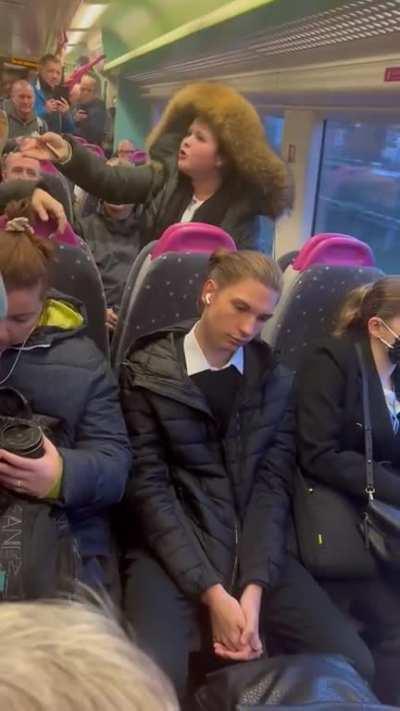 My Man at the front is trying to initiate an out of body experience to escaoe being trapped on the train with the hard cringe going on behind.