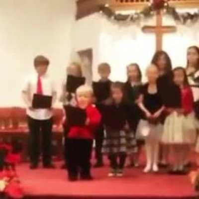 This little fella know how to spice up a children's choir